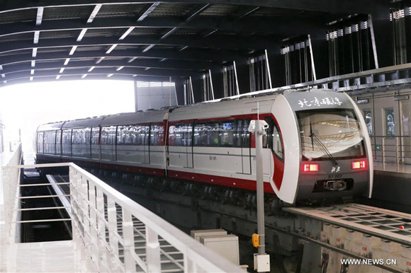 A train runs on the Line S1 in Beijing, capital of China, Dec. 30, 2017. The 10.2-km Line S1 is Beijing's first medium-low speed maglev line. It connects the western suburban districts of Mentougou and Shijingshan. Three more subway lines, which are Yanfang Line, Line S1 and West Suburb Line, started operation in Beijing Saturday, bringing the total length of metros in the Chinese capital to 608 kilometers. (Xinhua/Chen Xiaogen) A train runs on the Line S1 in Beijing, capital of China, Dec. 30, 2017. The 10.2-km Line S1 is Beijing's first medium-low speed maglev line. It connects the western suburban districts of Mentougou and Shijingshan. Three more subway lines, which are Yanfang Line, Line S1 and West Suburb Line, started operation in Beijing Saturday, bringing the total length of metros in the Chinese capital to 608 kilometers. (Xinhua/Chen Xiaogen)