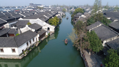 A man rows a boat on a river in Wuzhen water town in Zhejiang province last year. (Photo by LIANG ZHEN/FOR CHINA DAILY) A man rows a boat on a river in Wuzhen water town in Zhejiang province last year. (Photo by LIANG ZHEN/FOR CHINA DAILY)