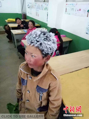 A third-grade boy at Zhuanshanbao Elementary School in Xinjie Town, Zhaotong City of Yunnan Province arrives at a classroom with his hair and eyebrows fully covered with frost. (Photo provided to China News Service)