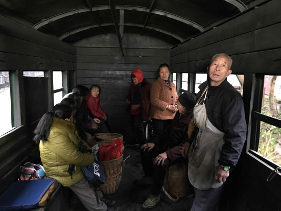 Local farmers living alongside the railway take the small train to the fair in town. /CGTN Photo Local farmers living alongside the railway take the small train to the fair in town. /CGTN Photo