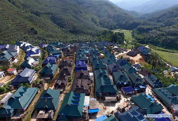 Photo taken on Sep 15, 2017 shows the bird's-eye view of Mannashan Village in Bulangshan Town of Menghai County, Southwest China's Yunnan province. A total of 524 people of the Bulang ethnic group live at the village and most of them have built new houses with the help of government under a policy of poverty alleviation. (Photo/Xinhua) Photo taken on Sep 15, 2017 shows the bird's-eye view of Mannashan Village in Bulangshan Town of Menghai County, Southwest China's Yunnan province. A total of 524 people of the Bulang ethnic group live at the village and most of them have built new houses with the help of government under a policy of poverty alleviation. (Photo/Xinhua)