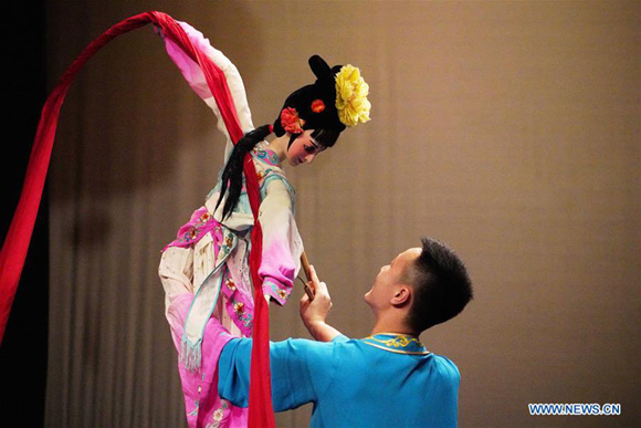 An artist performs puppet dance during a Chinese cultural performance at the Royal Cultural Center in Amman, Jordan, on Feb. 5, 2018. A series of Chinese cultural shows on Monday kicked off in Amman to celebrate the upcoming Chinese New Year which falls next week. (Xinhua/Lin Xiaowei)  AMMAN, Feb. 5 (Xinhua) -- A series of Chinese cultural shows on Monday kicked off in Jordanian capital Amman to celebrate the upcoming Chinese New Year which falls next week.  The cultural performance was held by the Chinese embassy in Amman in cooperation with Jordan's Ministry of Culture and the Greater Amman Municipality at the Royal Cultural Center.  The shows include folk music, traditional dance, acrobatics, puppet dance and mysterious Sichuan opera face-changing performed by artists from Chengdu Tianfu Cultural Troupe.  Addressing the event, Chinese Ambassador to Jordan, Pan Weifang, said China-Jordan ties have witnessed increased cooperation in fields of culture and economy.  He added that a Chinese cultural center will open in Jordan this year.
