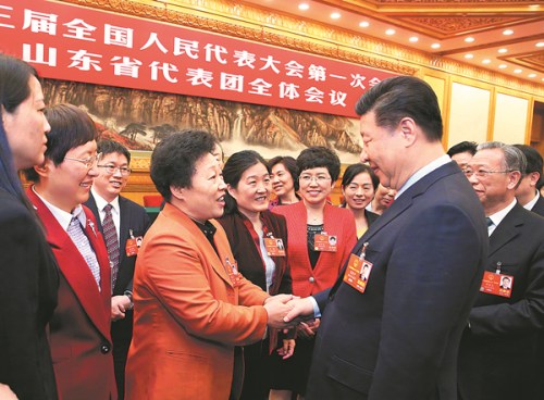 President Xi Jinping, who is also general secretary of the Communist Party of China Central Committee, speaks with deputies to the National People's Congress from Shandong province at a panel discussion on Thursday in Beijing. (Photo/Xinhua)