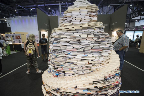 Photo taken on April 25, 2018 shows a spiral of books at the Geneva Book and Press Fair in Geneva, Switzerland. The annual Geneva Book and Press Fair opened on Wednesday, and is expected to attract nearly 100,000 visitors in five days of exhibition. (Xinhua/Xu Jinquan)