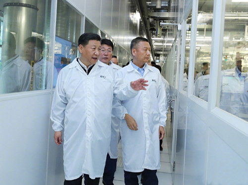 President Xi Jinping visits an integrated circuit production line at a technology company in Wuhan on Thursday. The largest city in Central China, Wuhan is a focal point in the economic belt being developed under the president's guidance. (Photo/Xinhua) President Xi Jinping visits an integrated circuit production line at a technology company in Wuhan on Thursday. The largest city in Central China, Wuhan is a focal point in the economic belt being developed under the president's guidance. (Photo/Xinhua)