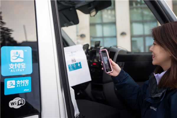A Chinese visitor scans a code with her phone during a trip to Rovaniemi, Finland, where travelers can use Alipay, China's popular mobile-payment app, for payments. (Photo provided to China Daily)