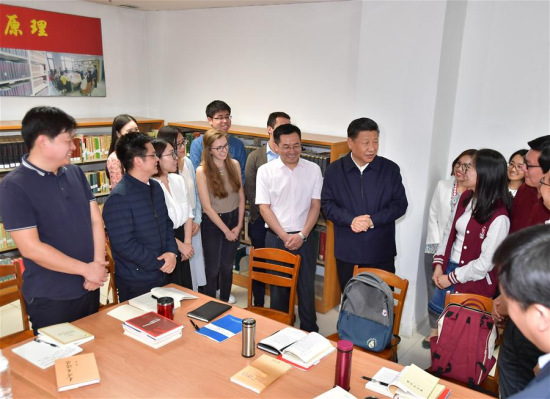 Chinese President Xi Jinping, also general secretary of the Communist Party of China Central Committee and chairman of the Central Military Commission, joins a group of Chinese and foreign students who are discussing topics related to interpreting the