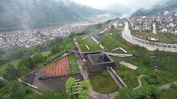 Many of the Wenchuan earthquake victims are buried in a mass grave on the mountain in Yingxiu. Their names are inscribed on an immense stone. (Nora Zheng/China Daily)