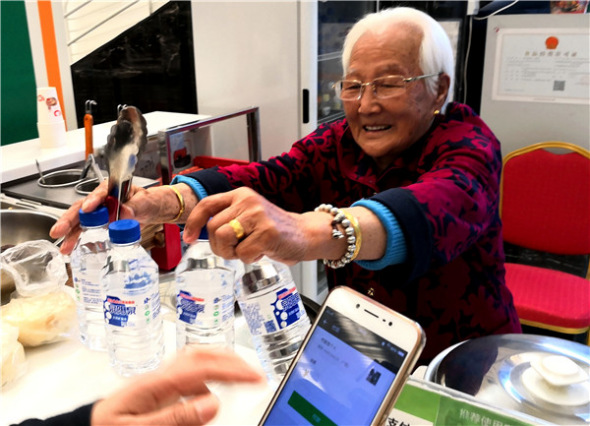 Jiang Naijun, 98, works at the 97 Supermarket she opened in July, in Changchun, Jilin province.(Photo provided to China Daily) Jiang Naijun, 98, works at the 97 Supermarket she opened in July, in Changchun, Jilin province.(Photo provided to China Daily)