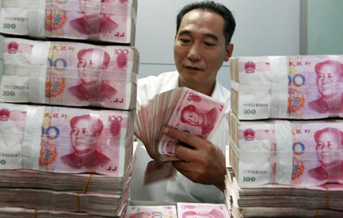 A clerk counts yuan notes at an Industrial and Commercial Bank of China branch in Huaibei, Anhui province. A renminbi bloc has been formed in East Asia, as nations in the region abandon the US dollar and peg their currency to the yuan, a sign of China's