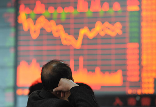 An investor at a brokerage in Fuyang, Anhui province, on Wednesday. An official from the China Securities Regulatory Commission said the Securities Investment Fund Law is to be modified to prepare for the listing of foreign companies on the A-share market