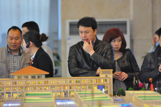 A man inspects a property model display on June 14, 2014 in Rizhao, Shandong province. (File photo/provided to China Daily) A man inspects a property model display on June 14, 2014 in Rizhao, Shandong province. (File photo/provided to China Daily)