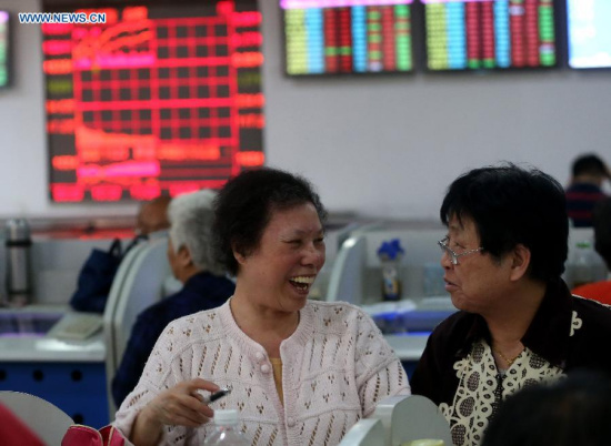 Stock investors follow information in a stock trading hall in east China's Shanghai, May 26, 2015. Chinese stocks rallied for the sixth successive day to close at a fresh seven-year high on Tuesday, with the benchmark Shanghai Composite Index surging 2.02 percent, or 97.1 points, to finish at 4,910.90 points. The Shenzhen Component Index gained 3.38 percent, or 552.42 points, to close at 16,903.47 points. (Xinhua/Pei Xin) Stock investors follow information in a stock trading hall in east China's Shanghai, May 26, 2015. Chinese stocks rallied for the sixth successive day to close at a fresh seven-year high on Tuesday, with the benchmark Shanghai Composite Index surging 2.02 percent, or 97.1 points, to finish at 4,910.90 points. The Shenzhen Component Index gained 3.38 percent, or 552.42 points, to close at 16,903.47 points. (Xinhua/Pei Xin)