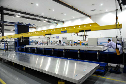Workers operate a machine in a workshop of the Hafei Airbus Composite Manufacturing Center in Harbin, capital of northeast China's Heilongjiang Province, on December 12, 2014 (XINHUA) Workers operate a machine in a workshop of the Hafei Airbus Composite Manufacturing Center in Harbin, capital of northeast China's Heilongjiang Province, on December 12, 2014 (XINHUA)