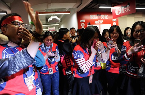 Employees of Tmall.com, a B2C platform operated by Alibaba Group, celebrate in the company's headquarters in Hangzhou, Zhejiang Province, after its turnover recorded an all-time high during the annual online shopping festival on November 11, 2014 (XINHUA) Employees of Tmall.com, a B2C platform operated by Alibaba Group, celebrate in the company's headquarters in Hangzhou, Zhejiang Province, after its turnover recorded an all-time high during the annual online shopping festival on November 11, 2014 (XINHUA)