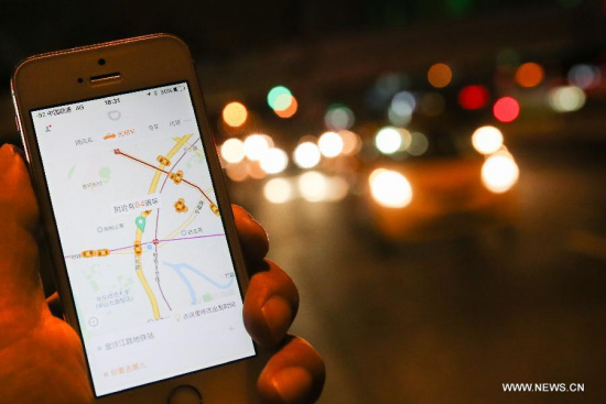 A citizen books taxi on a street in Shanghai, east China, Oct. 8, 2015. Shanghai's transport authority granted China's first license for running a ride-hailing platform to Didi Kuaidi, car service Uber's major rival in China, at a forum on Thursday. (Photo: Xinhua/Pei Xin) A citizen books taxi on a street in Shanghai, east China, Oct. 8, 2015. Shanghai's transport authority granted China's first license for running a ride-hailing platform to Didi Kuaidi, car service Uber's major rival in China, at a forum on Thursday. (Photo: Xinhua/Pei Xin)