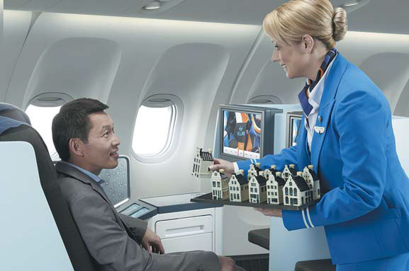 A KLM Royal Dutch Airlines stewardess serves a passenger. Provided to China Daily A KLM Royal Dutch Airlines stewardess serves a passenger. Provided to China Daily