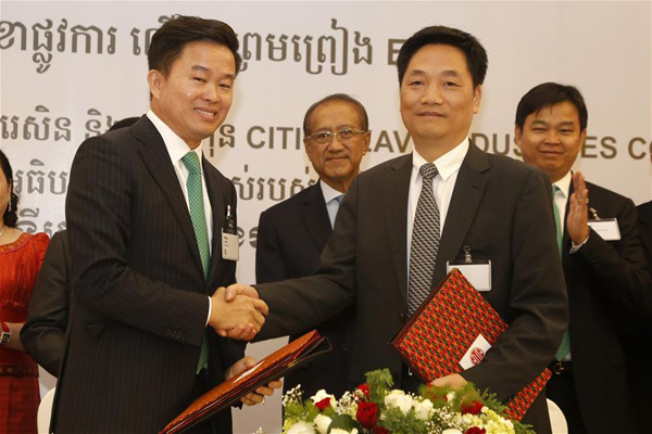 Yu Zhangfa (R), CITIC Heavy Industries Company CEO, shakes hands with Leang Meng, chief executive of Chip Mong Group, during a signing ceremony in Phnom Penh, Cambodia, Dec. 5, 2015. China's leading cement equipment manufacturer and service provider CITIC Heavy Industries Company on Saturday secured an engineering, procurement and construction (EPC) contract from a Cambodian conglomerate to build a 262 million-U.S.-dollar cement plant in Cambodia. (Xinhua/Phearum) Yu Zhangfa (R), CITIC Heavy Industries Company CEO, shakes hands with Leang Meng, chief executive of Chip Mong Group, during a signing ceremony in Phnom Penh, Cambodia, Dec. 5, 2015. China's leading cement equipment manufacturer and service provider CITIC Heavy Industries Company on Saturday secured an engineering, procurement and construction (EPC) contract from a Cambodian conglomerate to build a 262 million-U.S.-dollar cement plant in Cambodia. (Xinhua/Phearum)