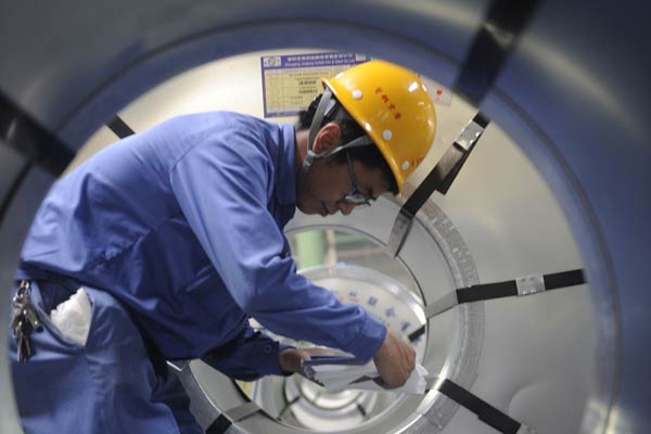 A worker is pictured in Shougang Jingtang United Iron & Steel Co on Aug 28, 2014. (Photo/Xinhua) A worker is pictured in Shougang Jingtang United Iron & Steel Co on Aug 28, 2014. (Photo/Xinhua)