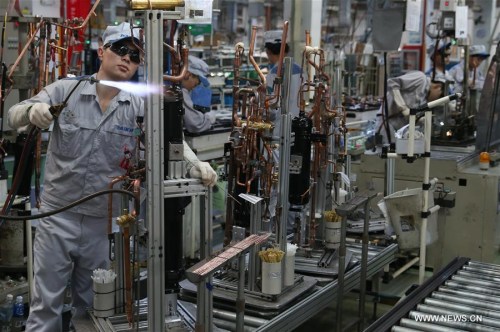 Workers are occupied on a production line at a factory in Xinzhuang industry zone in Shanghai, east China, July 30, 2015. China's economy grew by 6.9 percent in 2015. (Xinhua file photo/Pei Xin) Workers are occupied on a production line at a factory in Xinzhuang industry zone in Shanghai, east China, July 30, 2015. China's economy grew by 6.9 percent in 2015. (Xinhua file photo/Pei Xin)