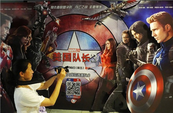 A cinema goer takes a picture of the Captain America 3 poster in Yichang, Hubei province. CHINA DAILY A cinema goer takes a picture of the Captain America 3 poster in Yichang, Hubei province. CHINA DAILY