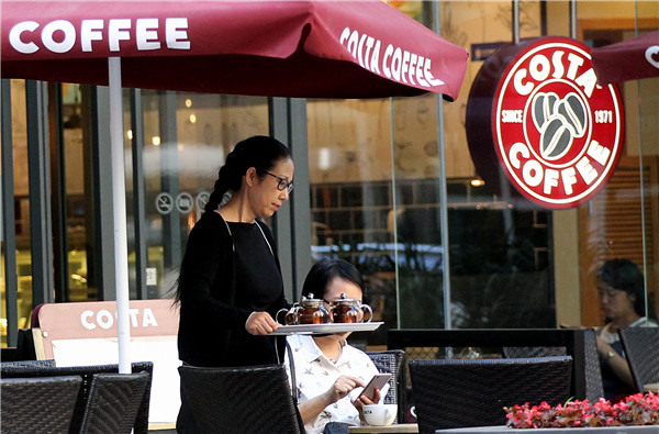 A waitress serves beverages to customers at a Costa cafe in Chaoyang District, Beijing.(ZHANG WEI/CHINA DAILY) A waitress serves beverages to customers at a Costa cafe in Chaoyang District, Beijing.(ZHANG WEI/CHINA DAILY)