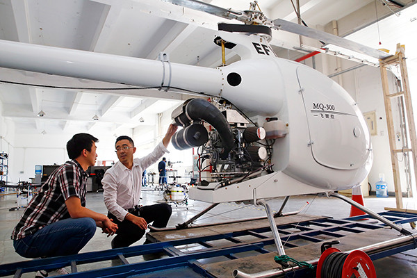 Technicians check a pilotless helicopter at a startup company in the Binhai New Area of Tianjin. (Photo provided to China Daily) Technicians check a pilotless helicopter at a startup company in the Binhai New Area of Tianjin. (Photo provided to China Daily)