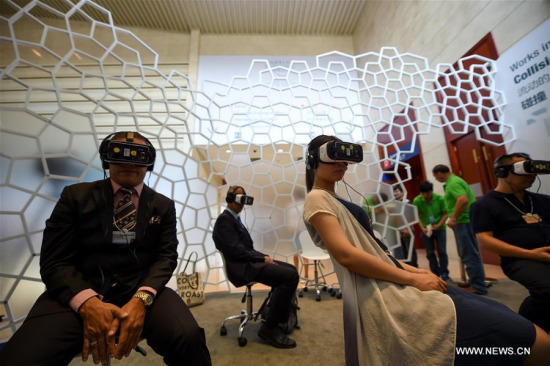 Visitors watch a movie with VR headsets at the exploration zone on the Annual Meeting of the New Champions 2016, or the Summer Davos Forum, in Tianjin, north China, June 26, 2016. (Xinhua/Bai Yu) Visitors watch a movie with VR headsets at the exploration zone on the Annual Meeting of the New Champions 2016, or the Summer Davos Forum, in Tianjin, north China, June 26, 2016. (Xinhua/Bai Yu)
