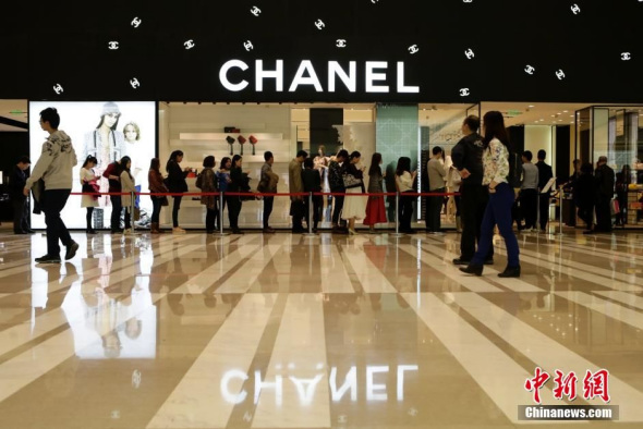 A file photo shows people line up to snap up Chanel products in Beijing. (Photo/Chinanews.com)