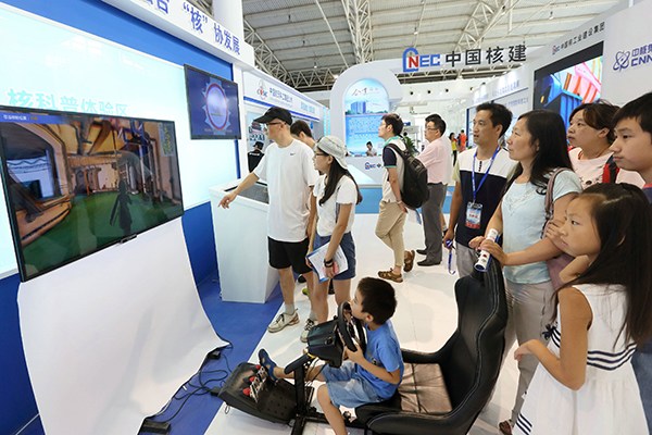 Visitors look at the stand of China National Nuclear Corp at an industry expo in Beijing. (Photo provided to China Daily) Visitors look at the stand of China National Nuclear Corp at an industry expo in Beijing. (Photo provided to China Daily)