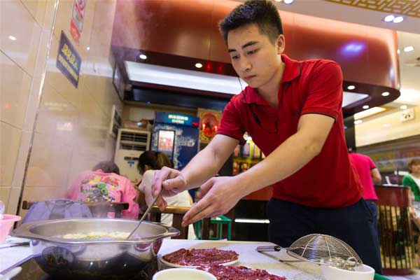 A restaurant attendant prepares beef for customers in Guangzhou, Guangdong province.(PROVIDED TO CHINA DAILY) A restaurant attendant prepares beef for customers in Guangzhou, Guangdong province.(PROVIDED TO CHINA DAILY)