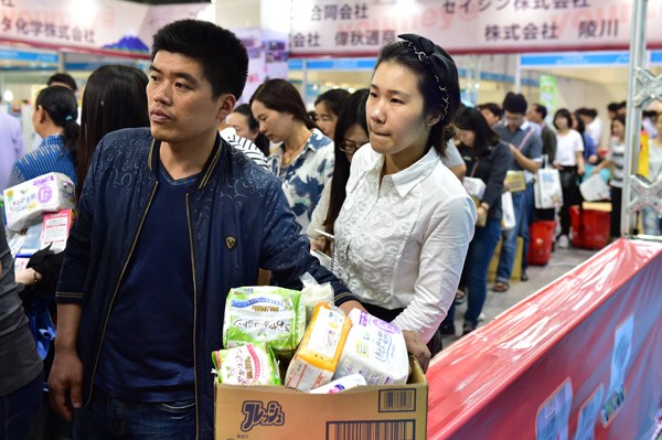 A couple wait in a queue to pay for some made-in-Japan baby diapers during a Japanese commodities fair in Yiwu, Zhejiang province. LV BING/CHINA DAILY A couple wait in a queue to pay for some made-in-Japan baby diapers during a Japanese commodities fair in Yiwu, Zhejiang province. LV BING/CHINA DAILY