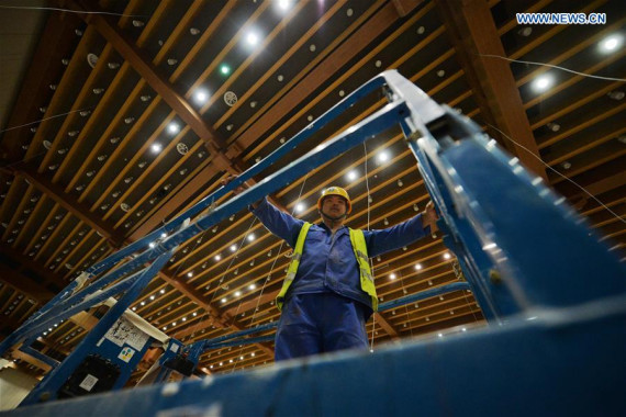 A constructor works at the main conference hall in the Silk Road International Convention Center in Dunhuang, northwest China's Gansu Province, Aug. 3, 2016. (Photo: Xinhua/Chen Bin)