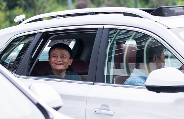 Jack Ma, founder and executive chairman of Alibaba Group Holding Ltd, sits in a newly launched sedan model of the Roewe RX5, an internet-connected SUV, jointly made by Alibaba and SAIC Motor Corp, last month in Hangzhou. (XU KANGPING/CHINA DAILY) Jack Ma, founder and executive chairman of Alibaba Group Holding Ltd, sits in a newly launched sedan model of the Roewe RX5, an internet-connected SUV, jointly made by Alibaba and SAIC Motor Corp, last month in Hangzhou. (XU KANGPING/CHINA DAILY)