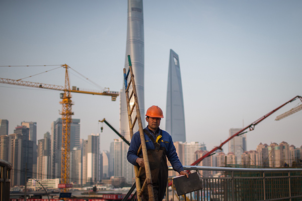 A worker walks through the construction site of a commercial property project in Pudong New Area of Shanghai. (Photo/China Daily) A worker walks through the construction site of a commercial property project in Pudong New Area of Shanghai. (Photo/China Daily)