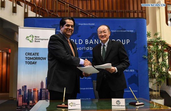 World Bank Group President Jim Yong Kim (R) and New Development Bank President K.V. Kamath shake hands after signing a memorandum in Washington D.C., the United States, Sept. 9, 2016.(Xinhua/Bao Dandan) World Bank Group President Jim Yong Kim (R) and New Development Bank President K.V. Kamath shake hands after signing a memorandum in Washington D.C., the United States, Sept. 9, 2016.(Xinhua/Bao Dandan)