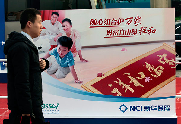 A man passes by the billboard of New China Life Insurance Co at an insurance fair in Beijing. (Photo:China Daily/A Qing) A man passes by the billboard of New China Life Insurance Co at an insurance fair in Beijing. (Photo:China Daily/A Qing)