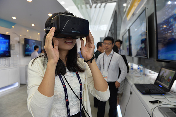 A visitor tries a VR device at a promotional event in Shanghai in July. (Photo/Xinhua) A visitor tries a VR device at a promotional event in Shanghai in July. (Photo/Xinhua)