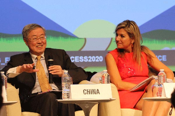 Zhou Xiaochuan, governor of the People's Bank of China, the central bank, speaks at seminar on financial inclusion held at the World Bank headquarters in Washington on Friday during the 2016 IMF/World Bank annual meeting while Queen Maxima of the Netherlands looks on. (Photo by Chen Weihua/China Daily) Zhou Xiaochuan, governor of the People's Bank of China, the central bank, speaks at seminar on financial inclusion held at the World Bank headquarters in Washington on Friday during the 2016 IMF/World Bank annual meeting while Queen Maxima of the Netherlands looks on. (Photo by Chen Weihua/China Daily)