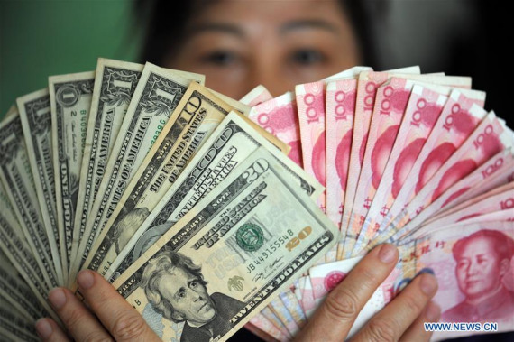 A residents shows China's RMB and US dollar banknotes in Qionghai, south China's Hainan Province, Jan. 7, 2016. (Xinhua file photo/Meng Zhongde) A residents shows China's RMB and US dollar banknotes in Qionghai, south China's Hainan Province, Jan. 7, 2016. (Xinhua file photo/Meng Zhongde)