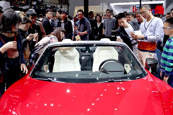 Visitors are attracted by a luxury car model at an auto show in Beijing. Cars with a price tag of 1.3 million yuan ($189,000) and above will have an additional 10 percent tax levied on them from Thursday. (Photo/China Daily) Visitors are attracted by a luxury car model at an auto show in Beijing. Cars with a price tag of 1.3 million yuan ($189,000) and above will have an additional 10 percent tax levied on them from Thursday. (Photo/China Daily)
