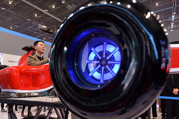 A visitor tries applications of China Mobile Communications Corp at the telecom carrier's booth at the World Internet of Things Expo in Wuxi, Jiangsu province. (Photo/China Daily) A visitor tries applications of China Mobile Communications Corp at the telecom carrier's booth at the World Internet of Things Expo in Wuxi, Jiangsu province. (Photo/China Daily)
