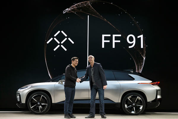 Jia Yueting (left), founder and CEO of LeEco, shakes hands with Nick Sampson, vice-president of Faraday Future, at the launch ceremony of the FF 91, an internet-enabled electric car, in Las Vegas, on Jan 3, 2017. (Photo provided to China Daily) Jia Yueting (left), founder and CEO of LeEco, shakes hands with Nick Sampson, vice-president of Faraday Future, at the launch ceremony of the FF 91, an internet-enabled electric car, in Las Vegas, on Jan 3, 2017. (Photo provided to China Daily)