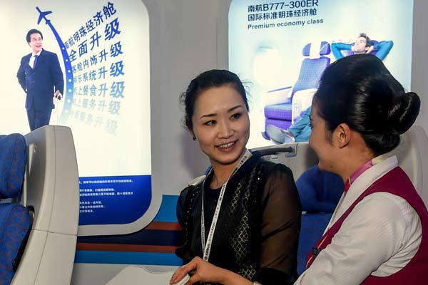 An employee (right) of China Southern Airlines introduces the airline's services to a visitor at an industry expo in Zhuhai, Guangdong province. (Photo/Xinhua) An employee (right) of China Southern Airlines introduces the airline's services to a visitor at an industry expo in Zhuhai, Guangdong province. (Photo/Xinhua)