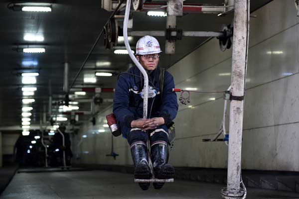 A miner takes an overhead man-riding device to come out of a mine of Shanxi Jincheng Anthracite Coal Mining Group in Jincheng, Shanxi province. (Photo/Xinhua) A miner takes an overhead man-riding device to come out of a mine of Shanxi Jincheng Anthracite Coal Mining Group in Jincheng, Shanxi province. (Photo/Xinhua)