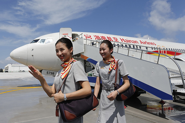 Crew members get off a plane of Hainan Airlines, a subsidiary of HNA Group Co, after landing at Nansha Islands. (Photo provided to China Daily) Crew members get off a plane of Hainan Airlines, a subsidiary of HNA Group Co, after landing at Nansha Islands. (Photo provided to China Daily)