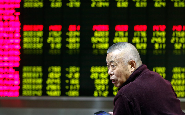 An investor checks out stock movements at a brokerage in Beijing on Friday, the first trading day of the Year of the Rooster. (Photo/China Daily) An investor checks out stock movements at a brokerage in Beijing on Friday, the first trading day of the Year of the Rooster. (Photo/China Daily)