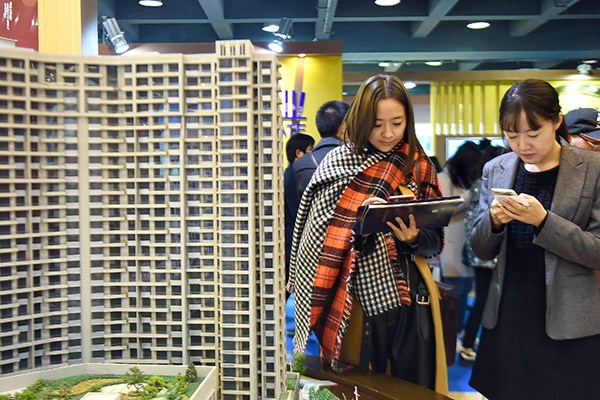 Prospective home buyers check out new property prices at a sales event in Hangzhou, Zhejiang province, East China, on Dec. 17, 2016. (Photo/China Daily) Prospective home buyers check out new property prices at a sales event in Hangzhou, Zhejiang province, East China, on Dec. 17, 2016. (Photo/China Daily)
