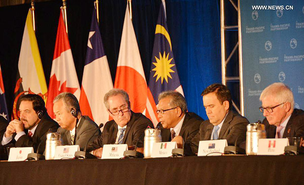 Trade ministers of the United States and 11 other Pacific Rim countries attend a press conference after negotiating the Trans-Pacific Partnership (TPP) trade agreement in Atlanta, the United States, on Oct. 5, 2015. (Photo/Xinhua)