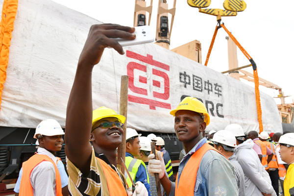 Workers take a selfie at a locomotive delivery ceremony in Mombasa, Kenya. The eight China-made locomotives will be used on the Mombasa-Nairobi railway. (Photo/Xinhua) Workers take a selfie at a locomotive delivery ceremony in Mombasa, Kenya. The eight China-made locomotives will be used on the Mombasa-Nairobi railway. (Photo/Xinhua)